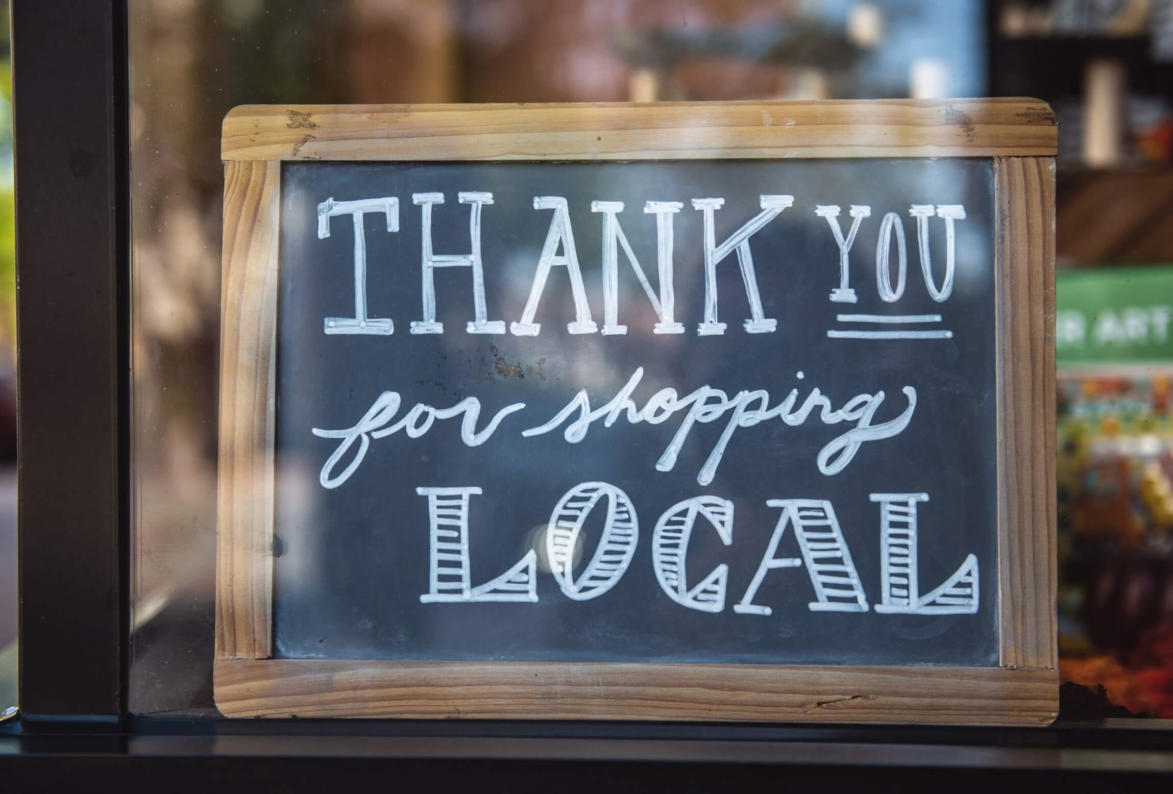 shop sign that says" thank you for shopping local"